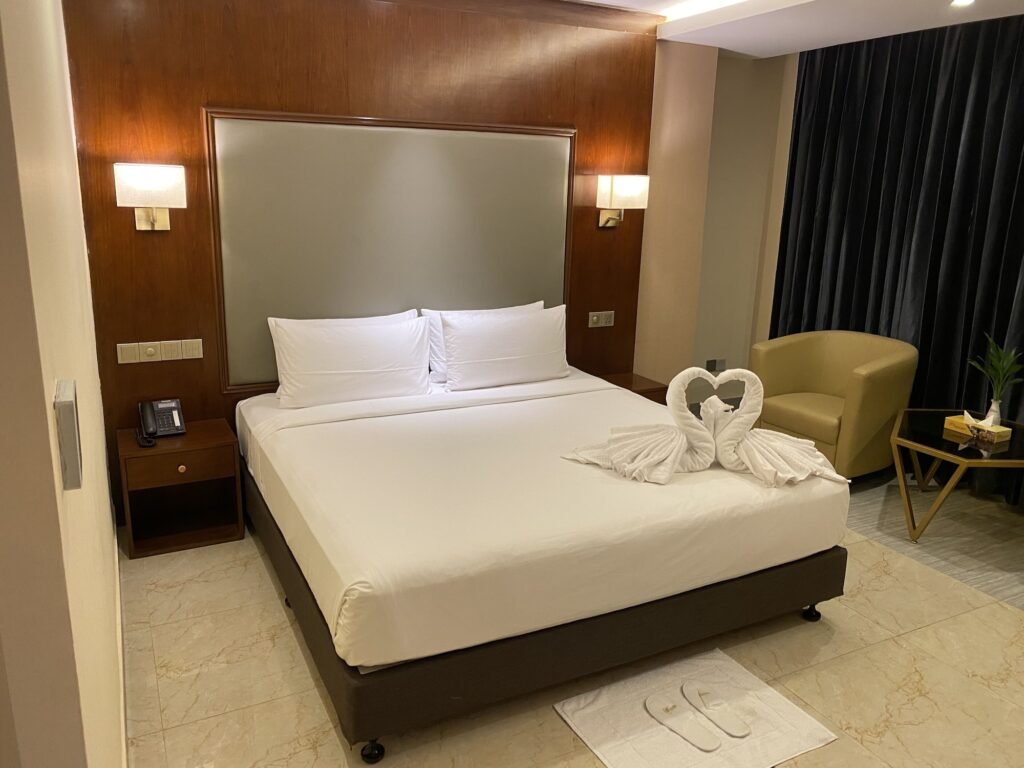 Deluxe king room with towel swans at Hotel Tower Inn, Chattogram