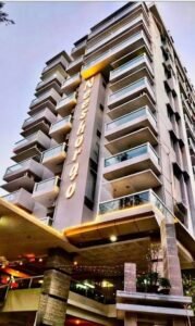 Neeshorgo Hotel and Resort tower exterior with illuminated branding, Kolatoli, Cox's Bazar