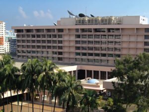 Pan Pacific Sonargaon Dhaka hotel building seen from the pool terrace with palm trees