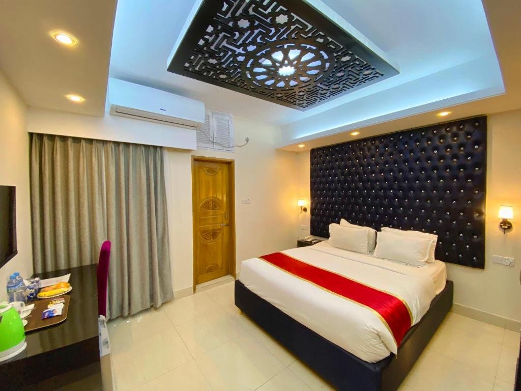 Deluxe Double room with gold tufted headboard and artwork at Park Hyatt, Banani, Dhaka