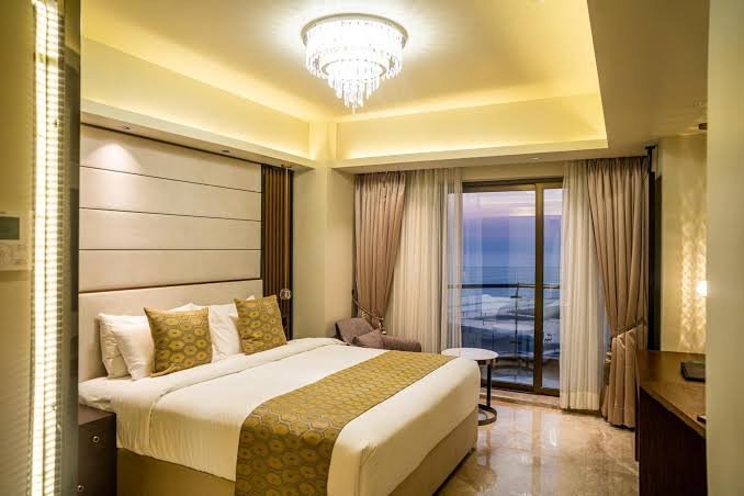 King bed guest room with a balcony and sea view at Ramada by Wyndham Cox's Bazar Kolatoli Beach