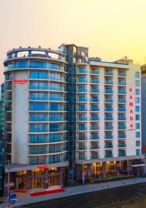 Ramada by Wyndham hotel tower in Kolatoli, Cox's Bazar, lit up at dusk