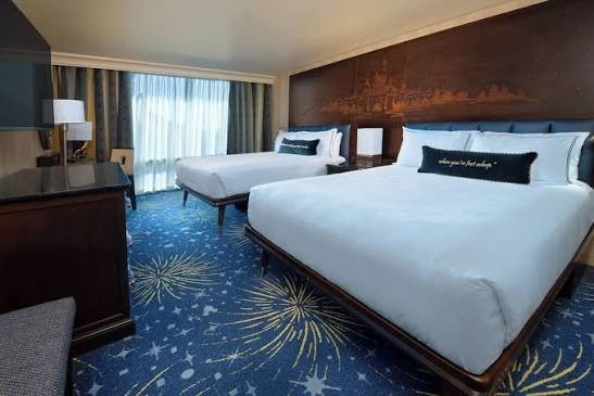Guest room with light-up Sleeping Beauty Castle headboard and fireworks-motif carpet at Disneyland Hotel, Anaheim