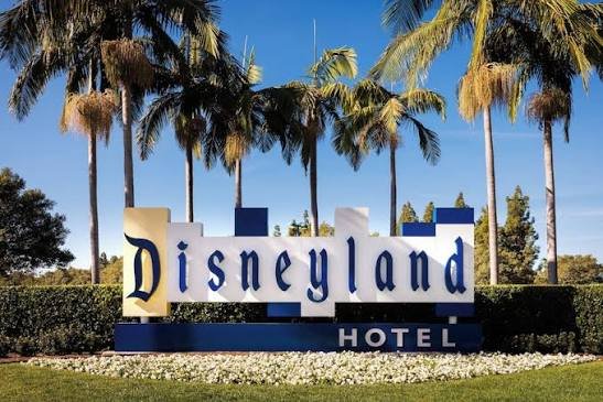 Disneyland Hotel entrance sign surrounded by palm trees, Anaheim, California