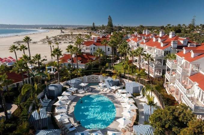 Aerial view of the circular cabana pool with the Victorian hotel building and beach beyond, Hotel del Coronado