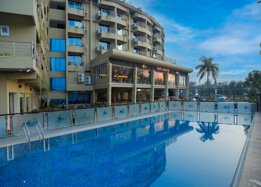 Outdoor swimming pool deck at Hotel Kollol by J&Z Group, Cox's Bazar