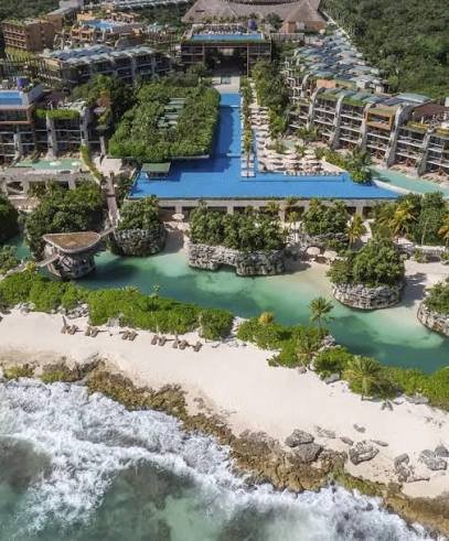 Aerial view of Hotel Xcaret Mexico's oceanfront pools and coves, Riviera Maya