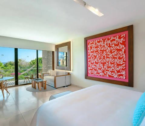 Ocean View Suite bedroom with Mexican artwork at Hotel Xcaret Mexico
