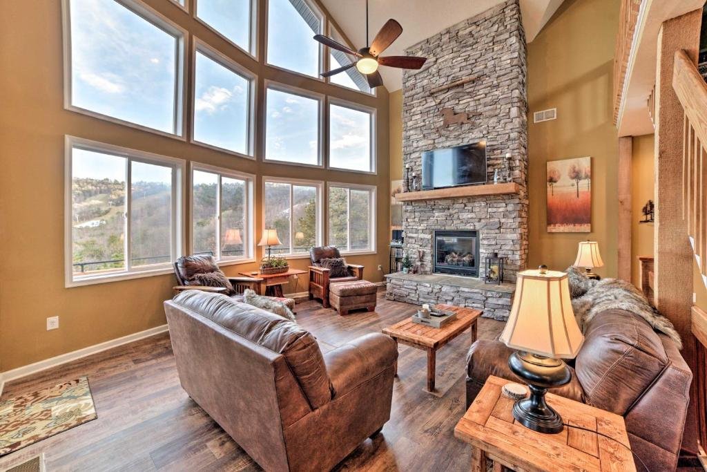 Luxury cabin living room with stone fireplace at Massanutten Resort