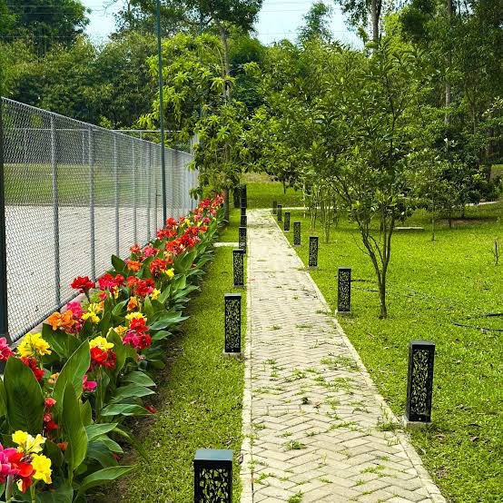 Flower-lined garden pathway at Seagull Resort and Spa Village, Tangail
